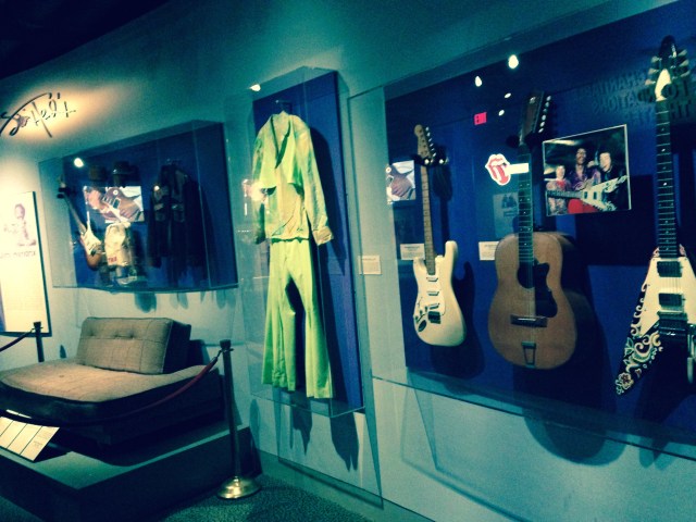 Jimi Hendrix exhibit, portion, including guitars, costumes, couch from home.